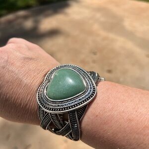 Silver cuff bracelet with green heart stone.